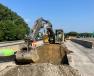 Excavation for temporary drainage installation to facilitate future traffic shifts takes place in the median.   (Shirley-Branch Joint Venture team photo)